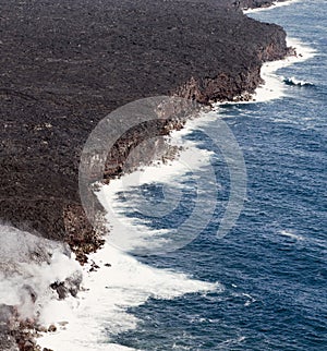 Kilauea lava enters the ocean, expanding coastline.