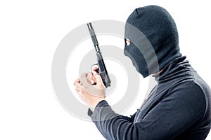 Killer with a gun in black clothes side view on a white