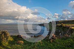 Kilt Rock, cliff, cloud and Lush grass in Isle of Skye, Scotland.