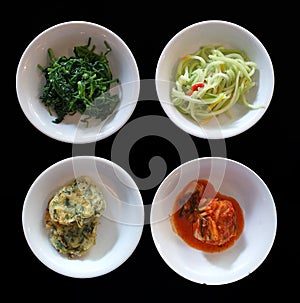 Kim chi cabbage, Sigeumchi Namul or seasoned spinach, sliced Chayote and Pajeon vegetable fritters