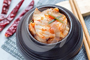 Kimchi cabbage. Korean appetizer in ceramic jar, horizontal, closeup photo