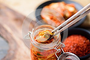 Kimchi cabbage in liter clamp jar eating with chopsticks