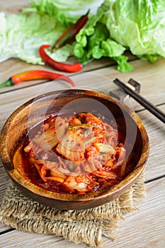 Kimchi with Chopsticks on wooden table
