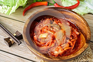 Kimchi with Chopsticks on wooden table