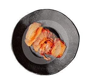 Kimchi Isolated, Kimchee on Black Plate, Red Spicy Kim Chi, Hot Fermented Napa Cabbage photo
