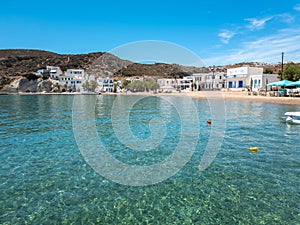 Kimolos island Psathi port Cyclades Greece. Shops cafe at seaside buildings blue sea