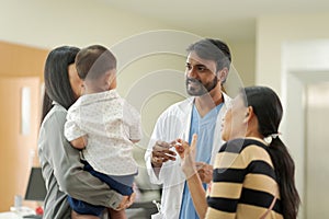 A kind doctor who treats pediatric patients. The child and his family brought him to see the doctor at the hospital because he was