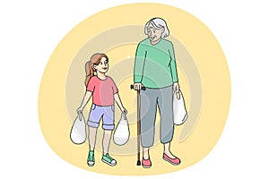 Kind small girl help old grandmother carrying bags