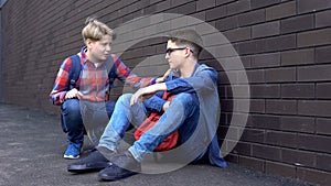 Kind teenage boy starting friendship with bullied student, helpline for children photo