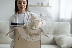 Kind young woman donating things to homeless people. photo