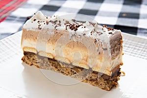 Kinder Cake slice served on white plate photo