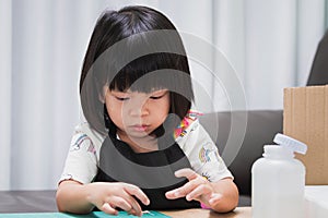 Kindergarten child glues the details of the craft paper box. Creative work by handmade. Project of kid`s creativity. Handicrafts