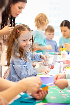 Kindergarten children doing arts and crafts in day care centre