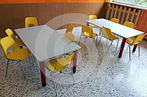 Kindergarten classroom with desks and yellow chairs