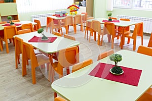 Kindergarten classroom with small chairs and tables