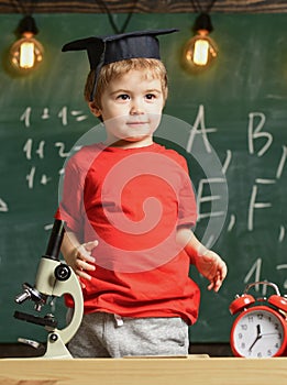 Kindergarten graduation concept. First former interested in studying, education. Child, pupil on smiling face near