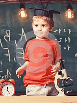 Kindergarten graduation concept. First former interested in studying, education. Child, pupil on smiling face near