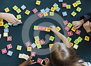 Kindergarten kids playing wooden alphabets letters vocabulary ga