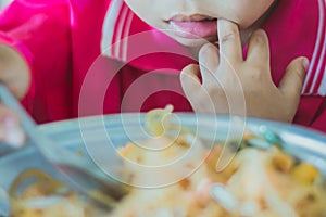 Kindergarten student is eating Pad Thai