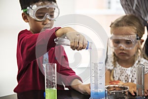 Kindergarten Students Mixing Solution in Science Experiment Laboratory Class