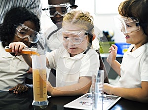 Kindergarten Students Mixing Solution in Science Experiment Laboratory Classr