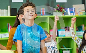 Kindergarten students stand up in classroom,preschool international education concept