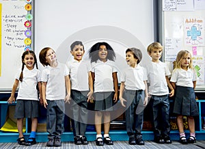 Kindergarten students standing together in clas