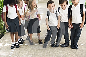 Kindergarten students standing together in scho