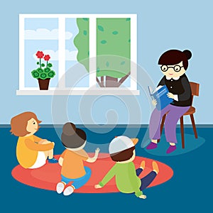 Kindergarten teacher reading book to children
