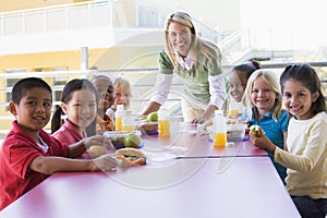 Kindergarten teacher supervising children