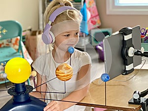 Kindergartener wearing a headset for online learning