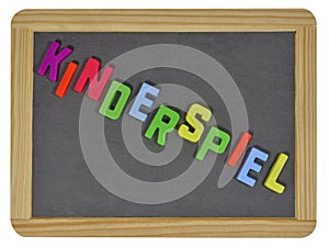 Kinderspiel in colored letters on slate