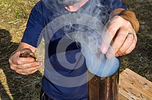 Kindling an old samovar through a pipe
