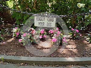 Kindly Curb Your Dog Sign Near A Flower Garden, NYC, NY, USA