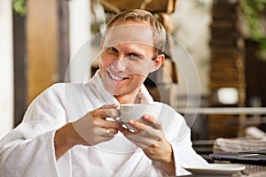 Kindly smiling man portrait with cup of morning co