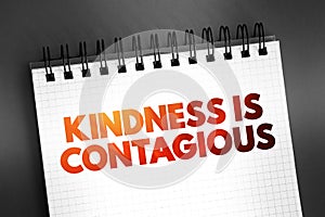 Kindness Is Contagious text quote on notepad, concept background