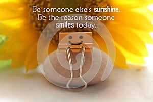 Kindness inspiraitonal quote - Be someone else`s sunshine. Be the reason someone smiles today. With smile paper clip and sunflower photo