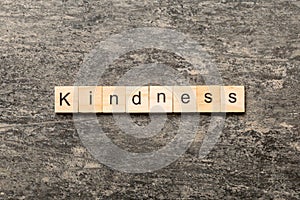 kindness word written on wood block. kindness text on table, concept