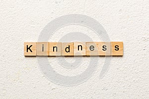 kindness word written on wood block. kindness text on table, concept