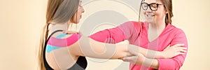 Kinesiology, physical therapy, rehabilitation banner. Female patient wearing kinesio tape on her shoulder exercising.