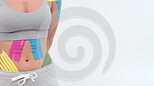 Kinesiology tape on girl belly. body with kinesio tape on the abdomen of young girl. Sport tratment rehabilitation