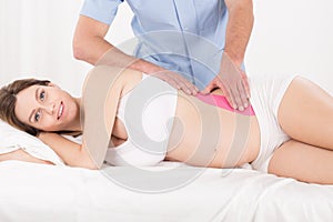 Kinesiology tape on pregnant belly