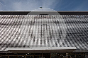 The kinetic facade of the building. Loose metal plates swing in waves in the wind