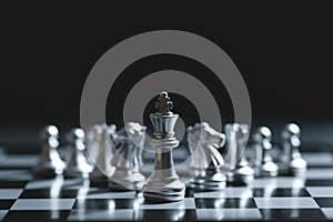 King of battle chess game stand on chessboard with black isolated background. Business leader concept