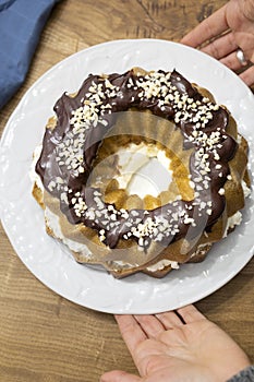 King cake with fresh homemade cream and dark chocolate and almonds photo
