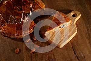 King cake or galette des rois in French. Epiphany pie with golden paper crown and little ceramic figurine