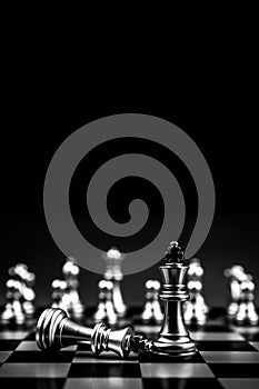 King chess pieces stand on falling chess in vertical concepts of challenge of leader business team or teamwork volunteer or wining