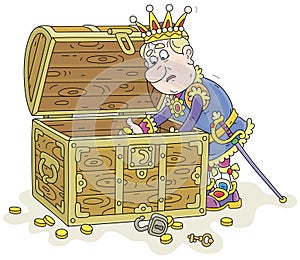 King counting last gold coins in his chest photo