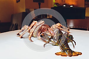 king crab and lobster live opposite each other on a white background. lying on the table against the background of the