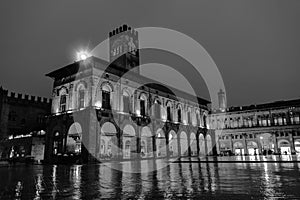 King Enzo palace at the main square of Bologna, Italy. Famous landmark at sunset at night. Black and white